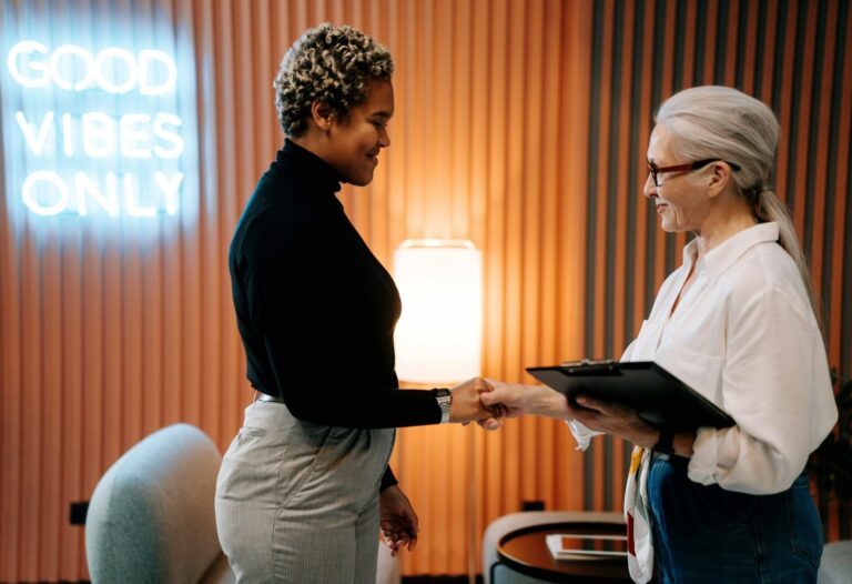 two hr professionals at work shaking hand