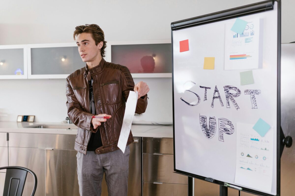 a person explaining on a whiteboard in office