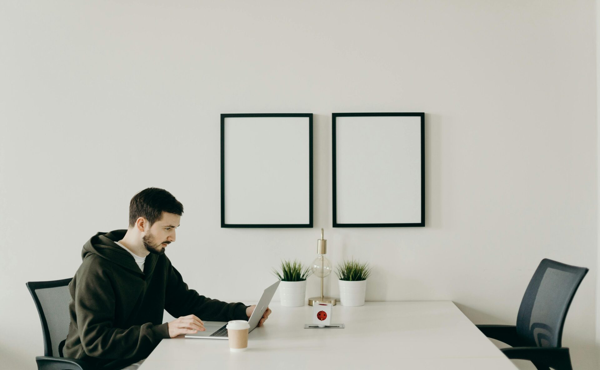 single person working on laptop in a meeting room