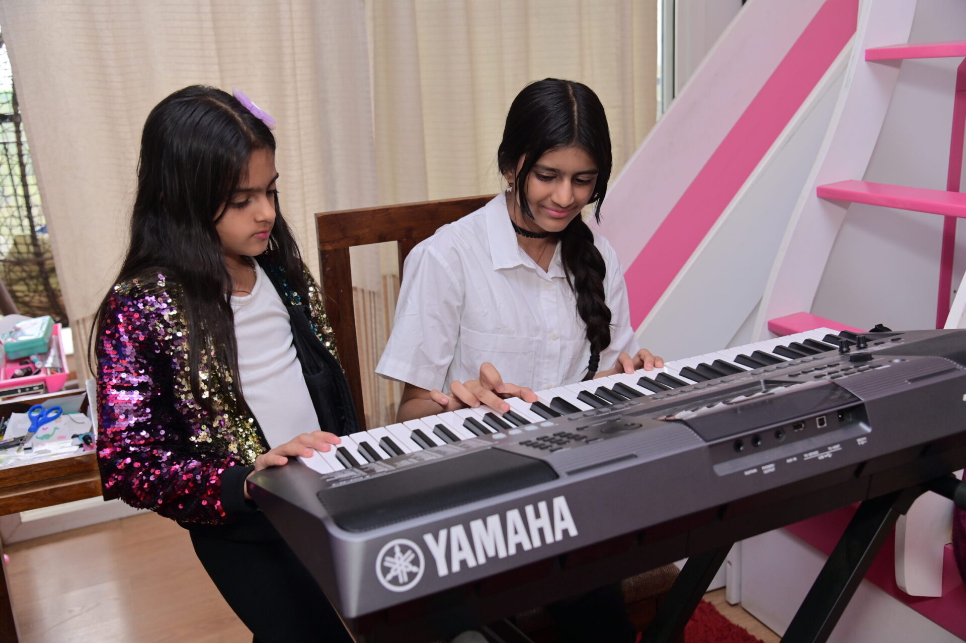 sisters practicing keyboard